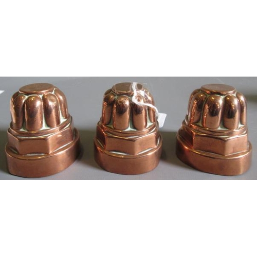 411 - TWO SETS OF THREE SMALL VICTORIAN COPPER JELLY MOULDS of fluted tapering cylindrical form, one set s... 