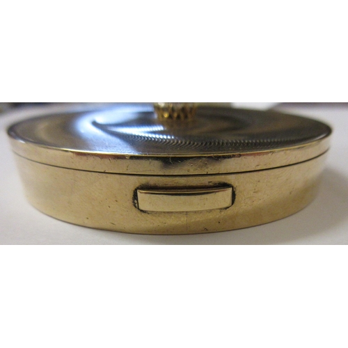 115 - A CARTIER ART DECO 9CT GOLD CIRCULAR COMPACT, London 1945, the concentric circle engine turned cover... 