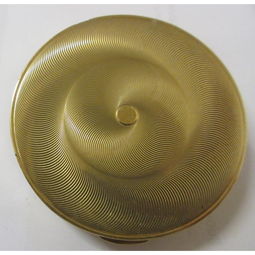 115 - A CARTIER ART DECO 9CT GOLD CIRCULAR COMPACT, London 1945, the concentric circle engine turned cover... 