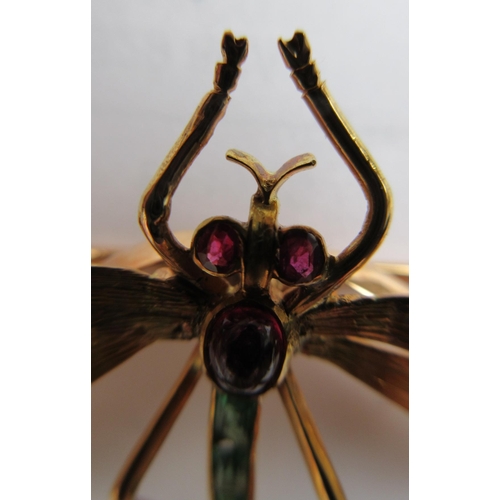 319 - A DRAGONFLY BROOCH with engraved wings, facet cut ruby eyes and cabochon thorax, and channel set gra... 