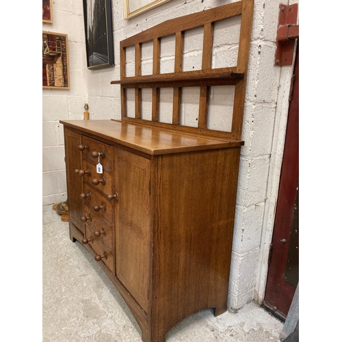 659 - A SMALL HEALS STYLE ARTS AND CRAFTS SIDEBOARD, late 19th century, the mildly arched open panelled ba... 