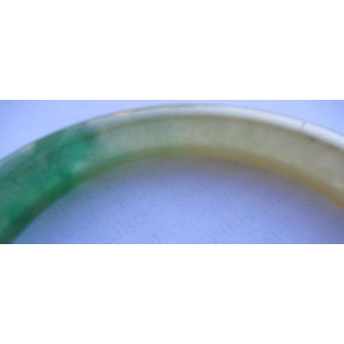 304 - A CHINESE POLISHED JADE BANGLE of D form, 37g, together with a silver mounted jade Shou pendant, sta... 