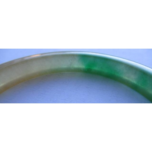 304 - A CHINESE POLISHED JADE BANGLE of D form, 37g, together with a silver mounted jade Shou pendant, sta... 