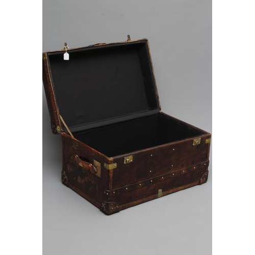 436 - A STUDDED TRAVEL TRUNK, early 20th century, made of wood and leather covered, with two side handles,... 