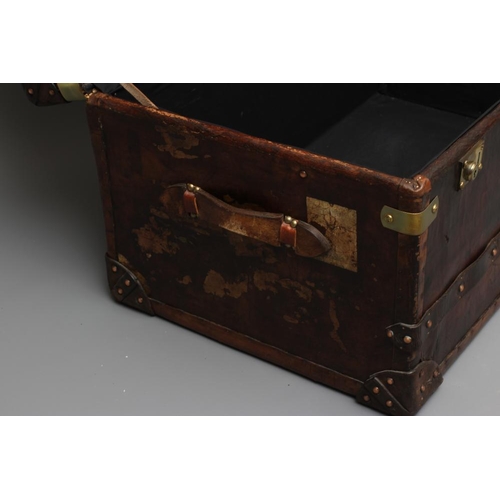 436 - A STUDDED TRAVEL TRUNK, early 20th century, made of wood and leather covered, with two side handles,... 