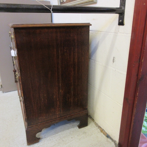 670 - A GEORGIAN OAK STRAIGHT FRONT CHEST, early 19th century, the moulded edged top over two short and th... 