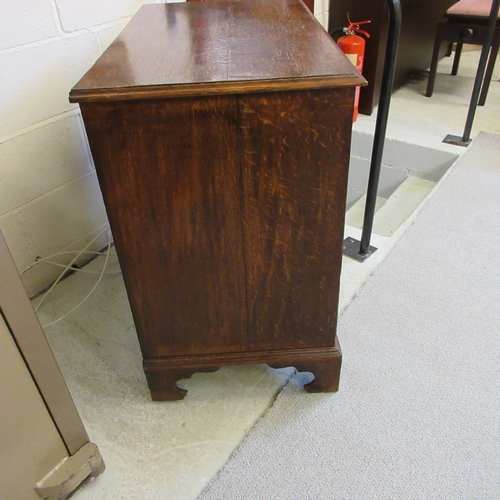 670 - A GEORGIAN OAK STRAIGHT FRONT CHEST, early 19th century, the moulded edged top over two short and th... 