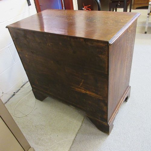 670 - A GEORGIAN OAK STRAIGHT FRONT CHEST, early 19th century, the moulded edged top over two short and th... 