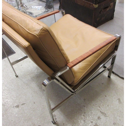 644 - A PAIR OF LEATHER AND CHROME FRAMED ARMCHAIRS, modern, the loose, tan cushions on a square section f... 