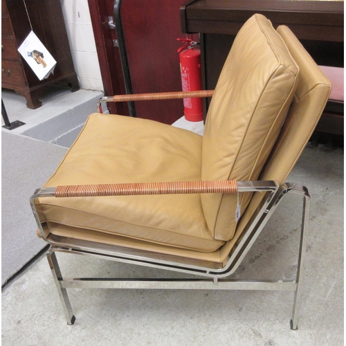 644 - A PAIR OF LEATHER AND CHROME FRAMED ARMCHAIRS, modern, the loose, tan cushions on a square section f... 