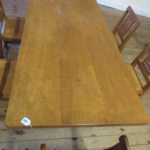 656 - A ROBERT THOMPSON ADZED OAK DINING TABLE, the rounded oblong top on trestle base with turned faceted... 