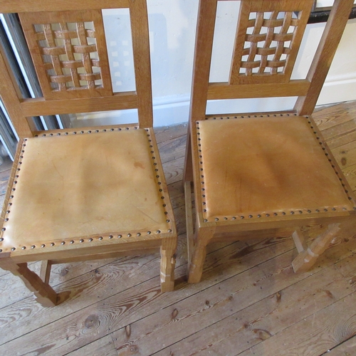 657 - A SET OF SIX ROBERT THOMPSON DINING CHAIRS (4 +2), of open lattice back form with padded cow hide se... 