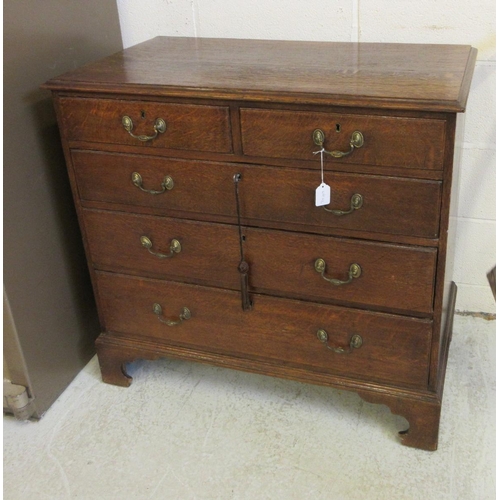 670 - A GEORGIAN OAK STRAIGHT FRONT CHEST, early 19th century, the moulded edged top over two short and th... 