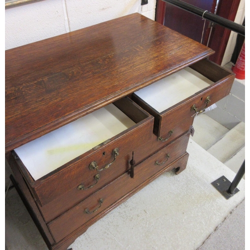 670 - A GEORGIAN OAK STRAIGHT FRONT CHEST, early 19th century, the moulded edged top over two short and th... 