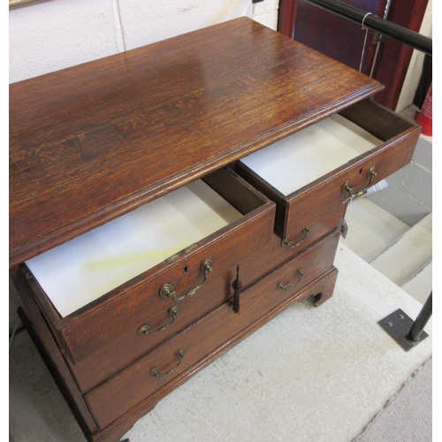 670 - A GEORGIAN OAK STRAIGHT FRONT CHEST, early 19th century, the moulded edged top over two short and th... 