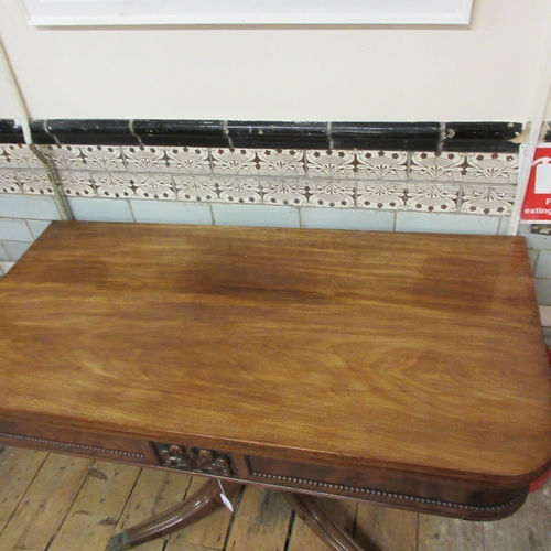 720 - A REGENCY MAHOGANY FOLDING BREAKFAST TABLE, early 19th century, the rounded oblong swivel top over p... 