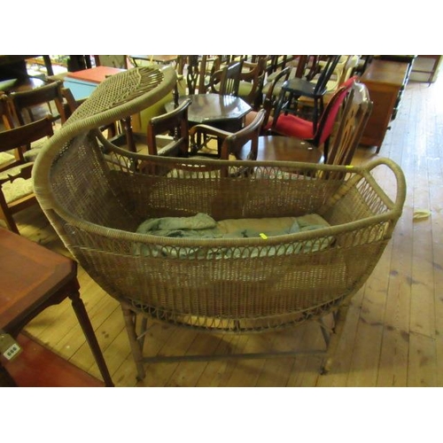 665 - ANTIQUE WICKER CRADLE