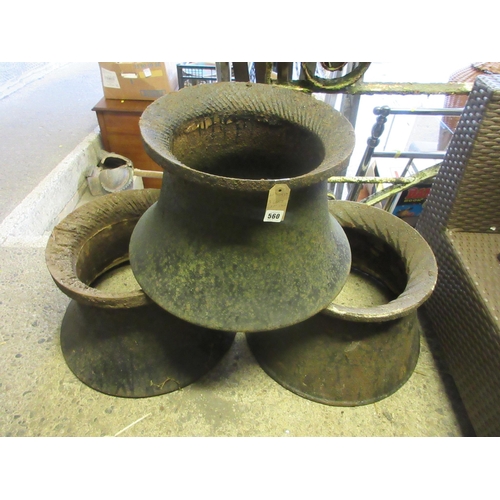 560 - THREE LARGE CAST IRON RINGS