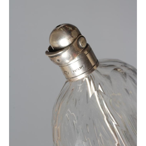 134 - A VICTORIAN SCENT FLASK by Thomas Johnson I, London 1875, the panel cut clear glass flattened oval f... 