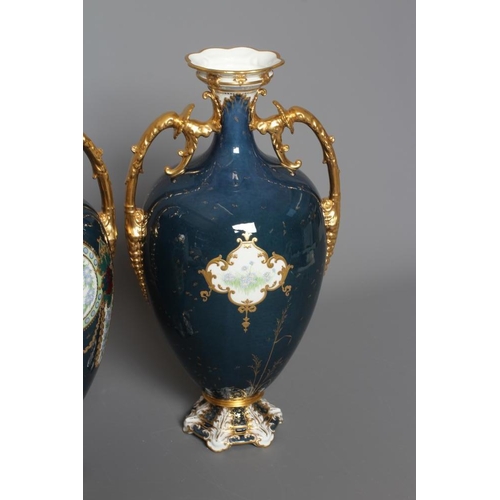 16 - A PAIR OF ROYAL CROWN DERBY CHINA VASES, 1925, of ovoid form with waisted necks and two gilded leaf ... 