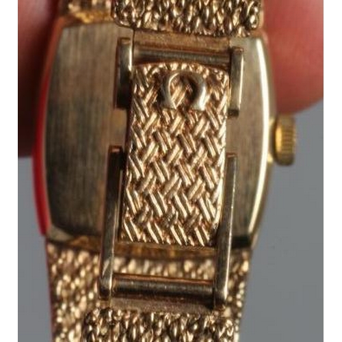 167 - A LADY'S 9CT GOLD OMEGA WRISTWATCH, the slightly convex rounded square mat silvered dial with applie... 