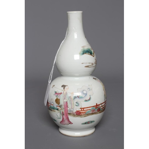 2 - A CHINESE PORCELAIN DOUBLE GOURD VASE painted in famille rose enamels with three figures in a fenced... 