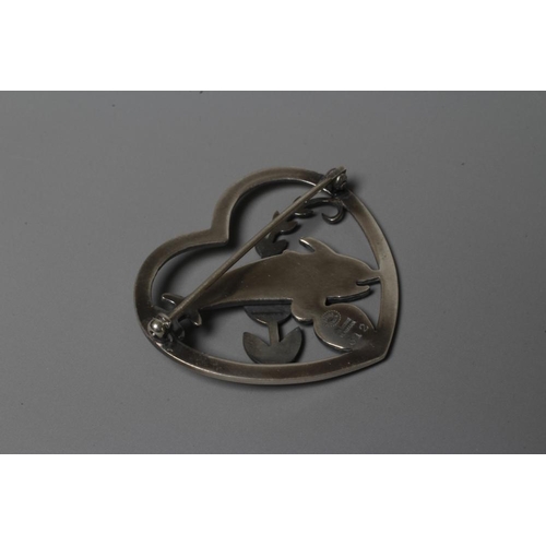 209 - A GEORG JENSEN SILVER HEART BROOCH designed by Arno Malinowski with two dolphins swimming amidst wee... 