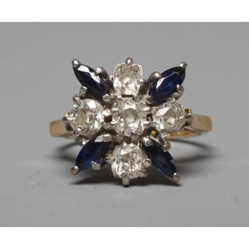 213 - A SAPPHIRE AND DIAMOND DRESS RING, the central cushion cut diamond claw set within a border of four ... 