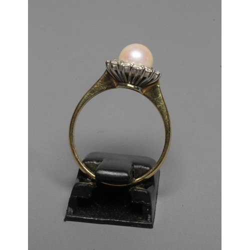 230 - A CULTURED PEARL AND DIAMOND CLUSTER DRESS RING, the central pearl within a border of twelve small d... 