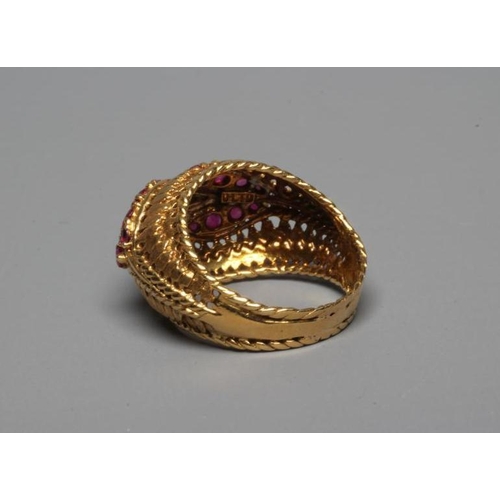 232 - A RUBY AND DIAMOND COCKTAIL RING, the high oval boss shaped panel centred by an elipse claw set with... 