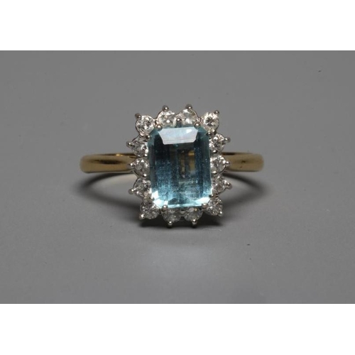 233 - AN AQUAMARINE AND DIAMOND SQUARE CLUSTER RING, the facet cut oblong aquamarine claw set to a border ... 