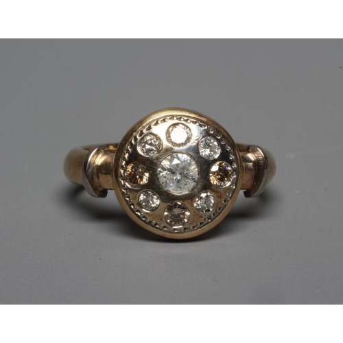 239 - A DIAMOND DRESS RING, the circular boss panel centred by a brilliant cut stone of approximately 0.25... 