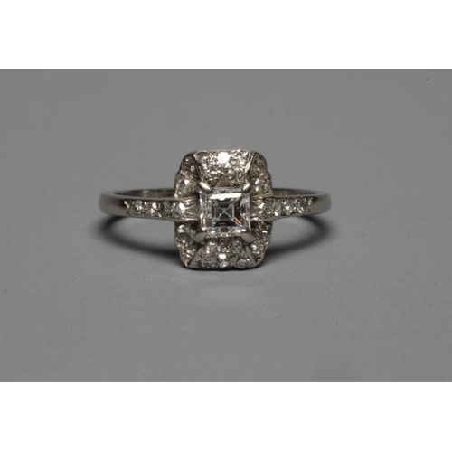 245 - AN ART DECO DIAMOND COCKTAIL RING, the central Princess cut stone claw set to a domed border set wit... 