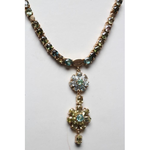 247 - A TOURMALINE FLOWERHEAD NECKLACE, the two mixed colour graduated flowerhead pendants hanging from a ... 