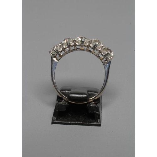 249 - A FIVE STONE DIAMOND RING, the central stone of approximately 0.5cts, all claw set to a plain white ... 