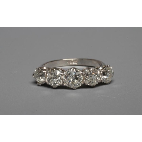 249 - A FIVE STONE DIAMOND RING, the central stone of approximately 0.5cts, all claw set to a plain white ... 