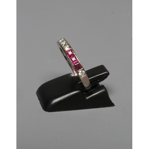 253 - A RUBY AND DIAMOND HALF HOOP ETERNITY RING with two panels of three channel set square cut rubies al... 