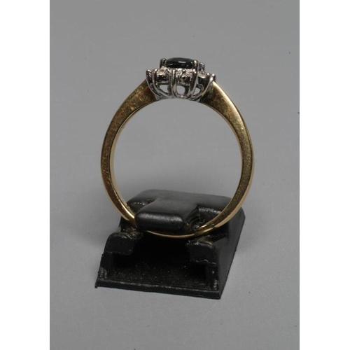 257 - A CLUSTER RING, the oval facet cut topaz (?) claw set to a border of twelve small brilliant cut diam... 