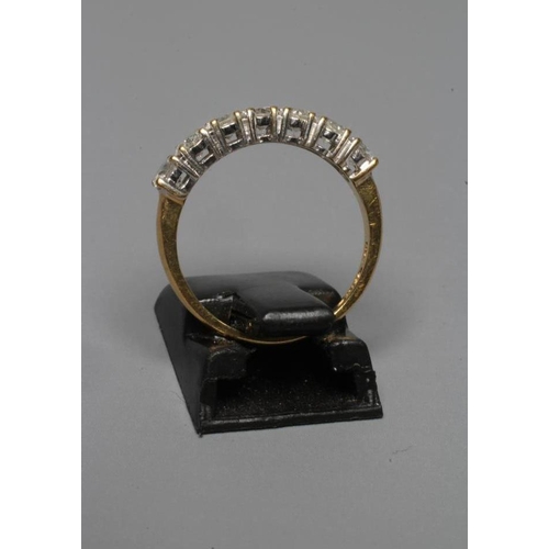 266 - A SEVEN STONE DIAMOND HALF HOOP RING, the round brilliant cut stones totalling 1ct claw set to a pla... 