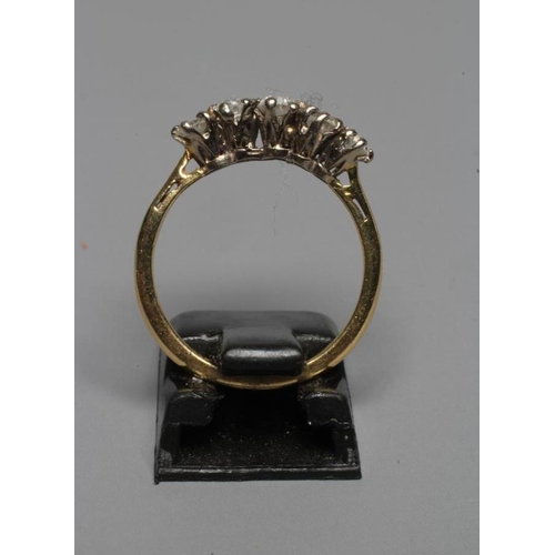 267 - A FIVE STONE DIAMOND RING, the old brilliant cut stones claw set to a plain shank stamped 18ct, size... 