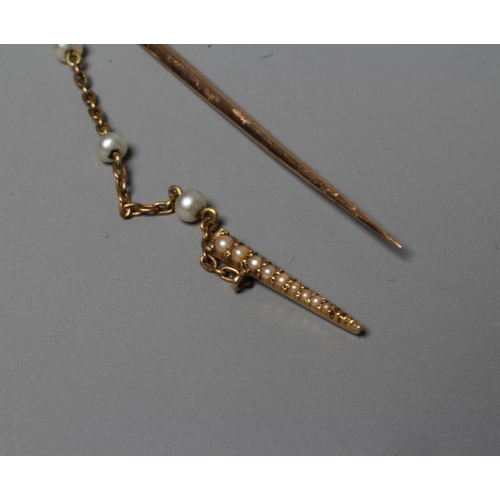 272 - AN EDWARDIAN NOVELTY JABOT PIN in the form of a court sword with seed pearl set basket hilt and quil... 