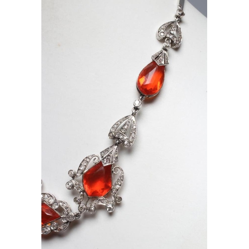 276 - A FIRE OPAL AND DIAMOND NECKLACE BY W. PHILLIPS, the briolette type cut opal drop with husk mount pe... 