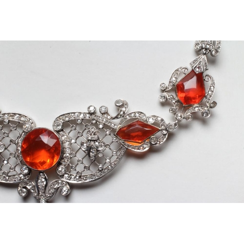 276 - A FIRE OPAL AND DIAMOND NECKLACE BY W. PHILLIPS, the briolette type cut opal drop with husk mount pe... 