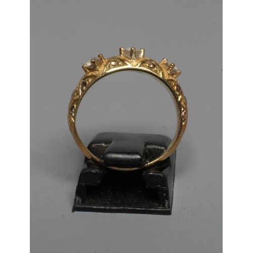 284 - A MID VICTORIAN THREE STONE DIAMOND RING, the old cut stones point set to a lattice chased mount and... 