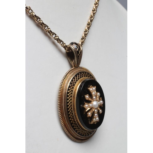 288 - A VICTORIAN MOURNING PENDANT, the oval black onyx panel centred by an inset cross set with seed pear... 