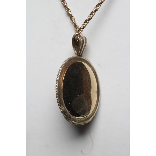 288 - A VICTORIAN MOURNING PENDANT, the oval black onyx panel centred by an inset cross set with seed pear... 