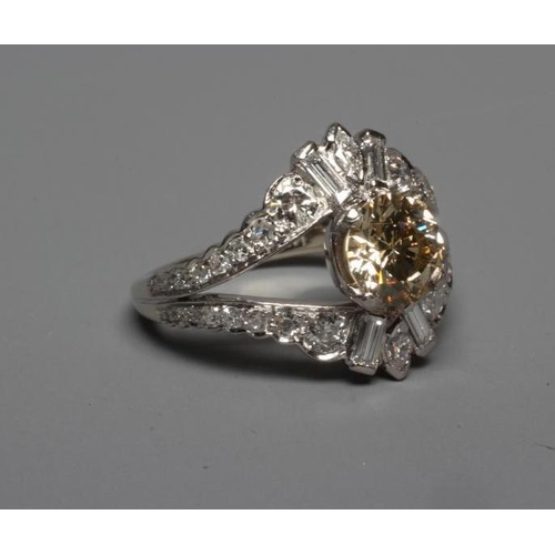 289 - A DIAMOND DRESS RING, the central cinnamon stone of approximately 1.2cts claw set to baguette and ma... 