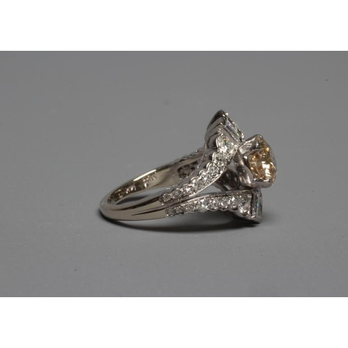 289 - A DIAMOND DRESS RING, the central cinnamon stone of approximately 1.2cts claw set to baguette and ma... 