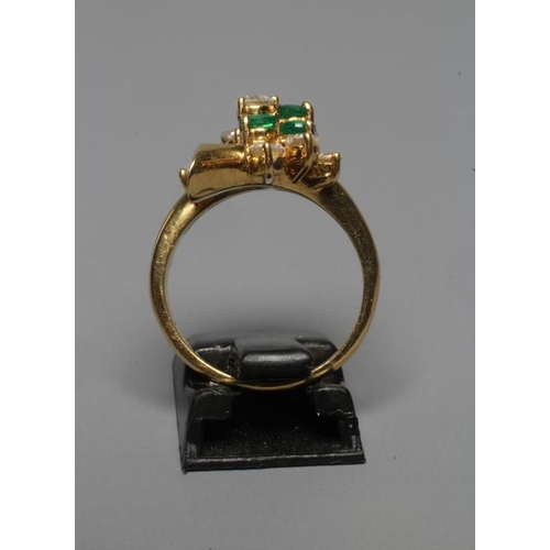 294 - AN EMERALD AND DIAMOND ABSTRACT CLUSTER RING, the five graduating emeralds claw set with ten round b... 