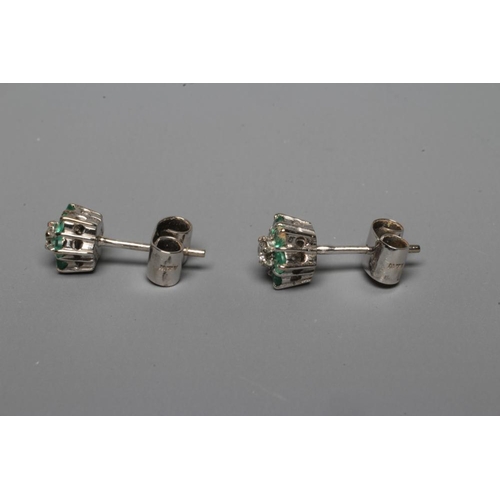 296 - A PAIR OF EMERALD AND DIAMOND EAR STUDS, the central small round brilliant cut diamond claw set to a... 